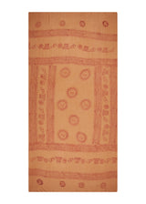 Packs down small in a beach bag. The Sand Om Sarong from The Dune Set, apricot tan, shown flat.