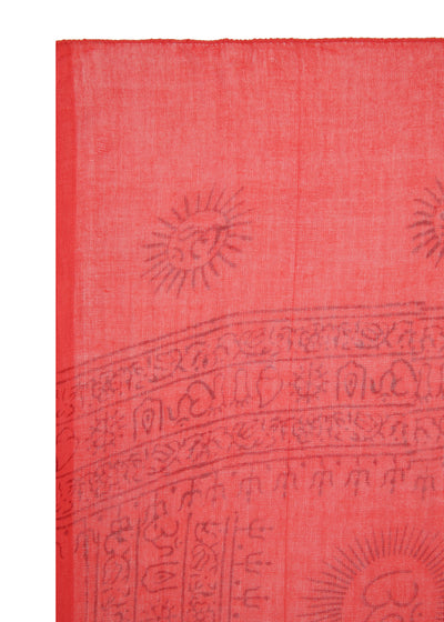 Made by hand in Nepal. Corner of the red Chilli Mini Om Sarong, a block-printed Om sun above the border stripes, hand-sewn hem down one side.