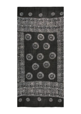 Hand block-printed in Nepal. The Midnight Om Sarong from The Forest Set, deep charcoal, spread out.