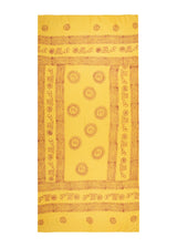 Wide enough to lie on. The Lemon Om Sarong from The Citrus Set, golden yellow, photographed against white.